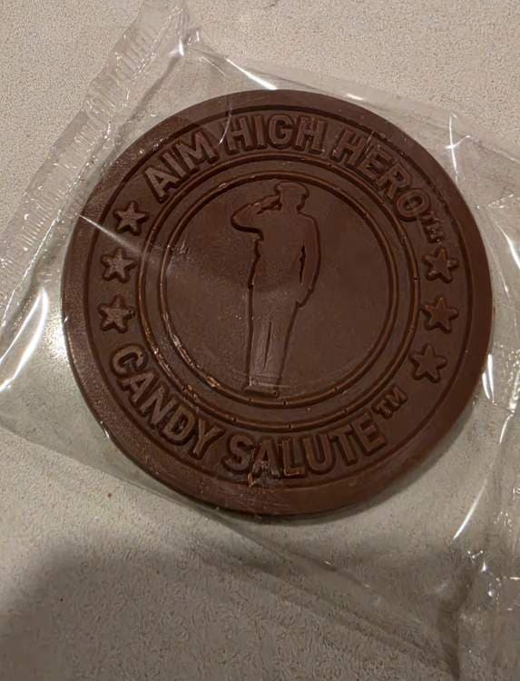 Actual round Candy Salute chocolate in a clear protective wrap