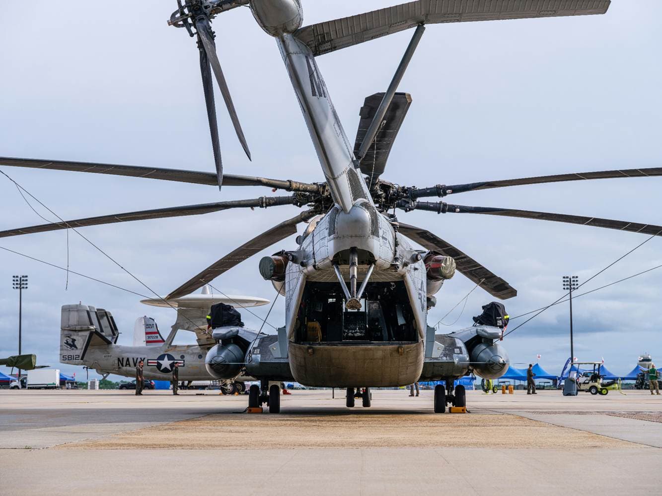U.S. Navy heavy lift helicopter viewed from behind on an airfield